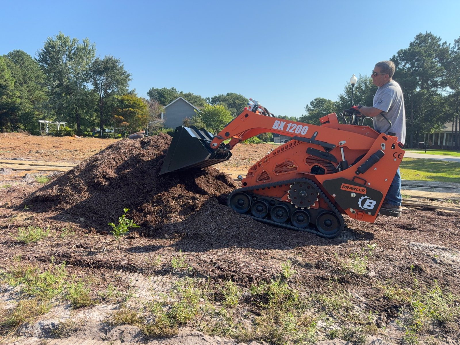 Mini skid steer bucket moving landscape material
